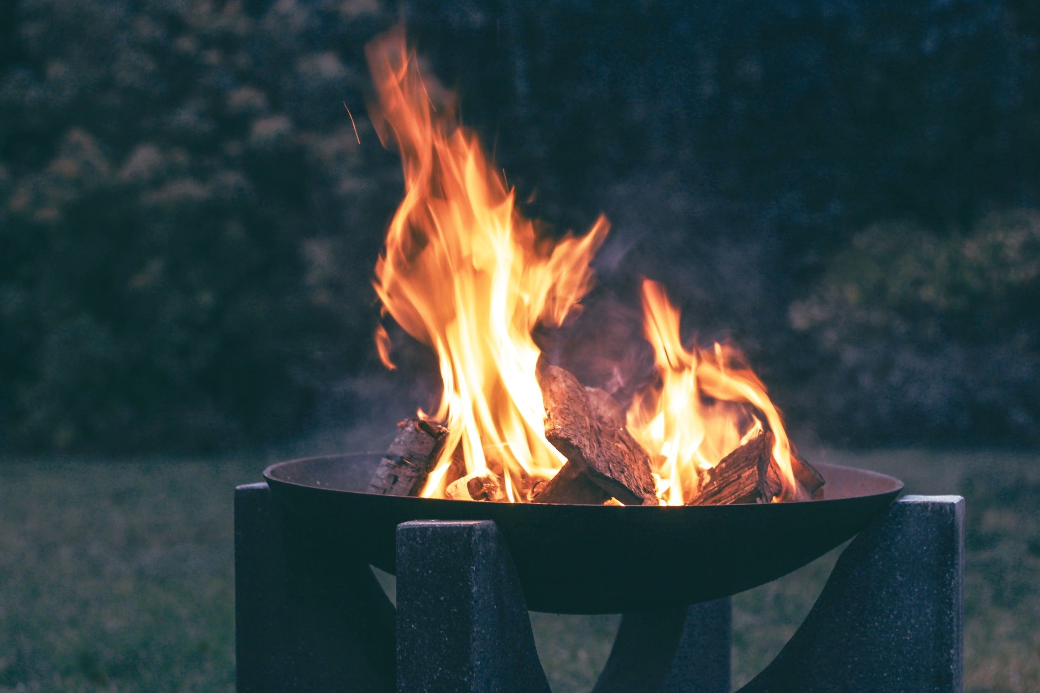 Fire pit with flames burning against a dark background