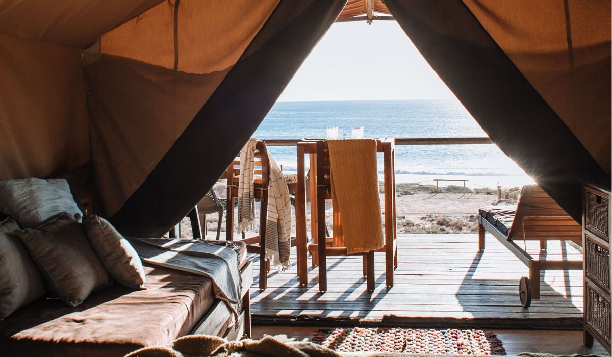 Glamping accommodation with a view of the ocean and beach.